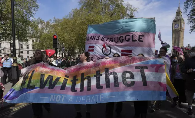 Campaigners take part in a rally organised by trans rights groups, trade unions, and community organisations following the Supreme Court ruling on the definition of a woman in equalities law, at Parliament Square, central London, Saturday April 19, 2025. (AP Photo/Alastair Grant)