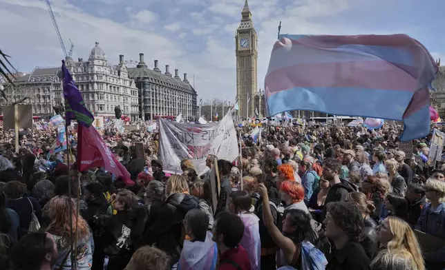 Campaigners take part in a rally organised by trans rights groups, trade unions, and community organisations following the Supreme Court ruling on the definition of a woman in equalities law, at Parliament Square, central London, Saturday April 19, 2025. (AP Photo/Alastair Grant)
