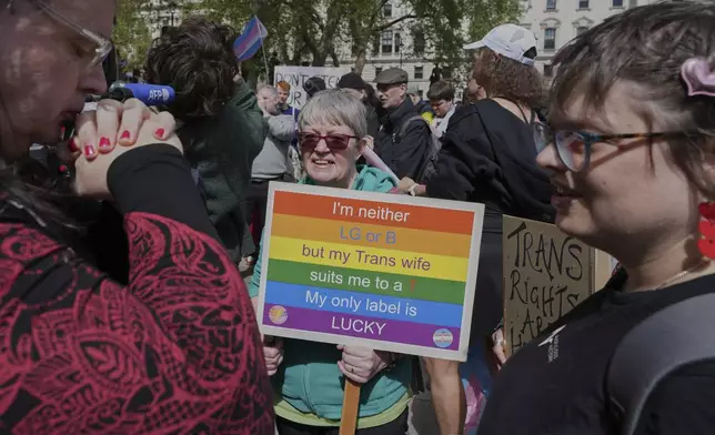 Campaigners take part in a rally organised by trans rights groups, trade unions, and community organisations following the Supreme Court ruling on the definition of a woman in equalities law, at Parliament Square, central London, Saturday April 19, 2025. (AP Photo/Alastair Grant)