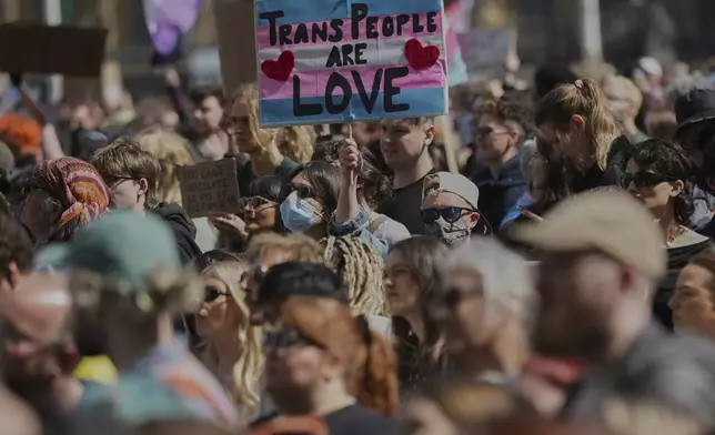 Campaigners take part in a rally organised by trans rights groups, trade unions, and community organisations following the Supreme Court ruling on the definition of a woman in equalities law, at Parliament Square, central London, Saturday April 19, 2025. (AP Photo/Alastair Grant)