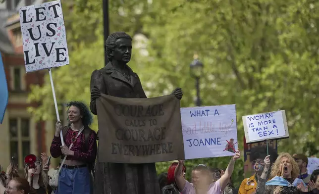 Campaigners take part in a rally organised by trans rights groups, trade unions, and community organisations following the Supreme Court ruling on the definition of a woman in equalities law, at Parliament Square, central London, Saturday April 19, 2025. (AP Photo/Alastair Grant)
