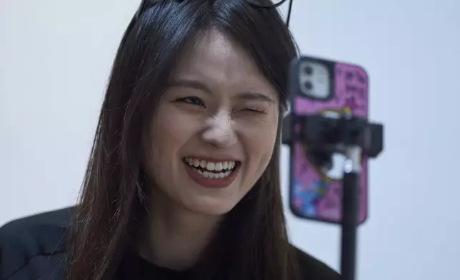 Tian Xin, a cyber matchmaker, hosts a livestream using the Chinese social media app Xiaohongshu (RedNote) from Hangzhou, China, early Friday, April 25, 2025. (AP Photo/Ng Han Guan)