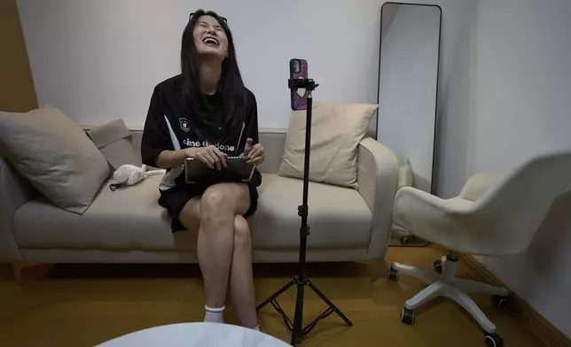 Tian Xin, a cyber matchmaker, hosts a livestream using the Chinese social media app Xiaohongshu (RedNote) from Hangzhou, China, early Friday, April 25, 2025. (AP Photo/Ng Han Guan)