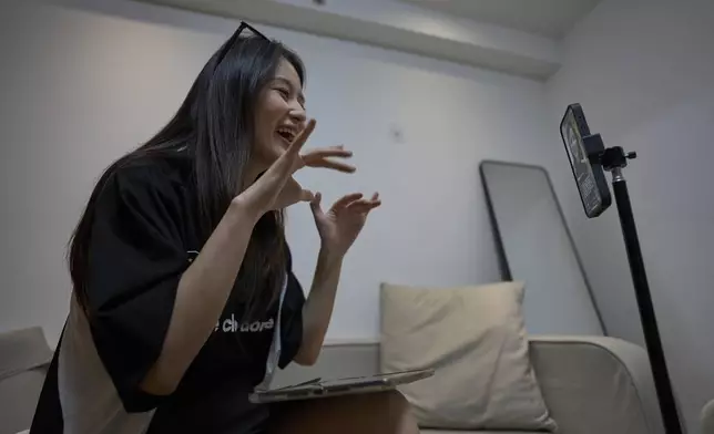 Tian Xin, a cyber matchmaker, hosts a livestream using the Chinese social media app Xiaohongshu (RedNote) from Hangzhou, China, early Friday, April 25, 2025. (AP Photo/Ng Han Guan)