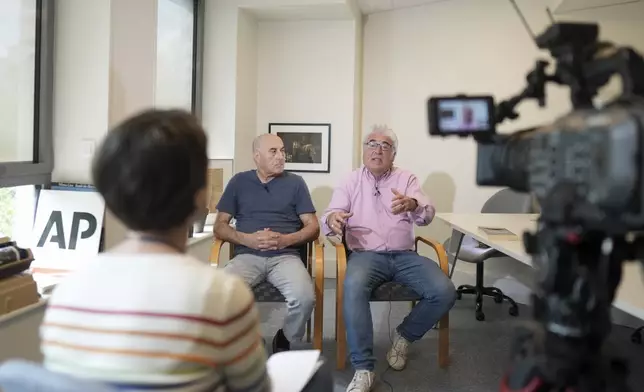 Yunice Abbas, left, one of the men accused in the 2016 armed robbery of Kim Kardashian and Thierry Niemen, co-author of the book "I Sequestered Kim Kardashian", answer the Associated Press, Tuesday, April 22, 2025 in Paris. (AP Photo/Thibault Camus)