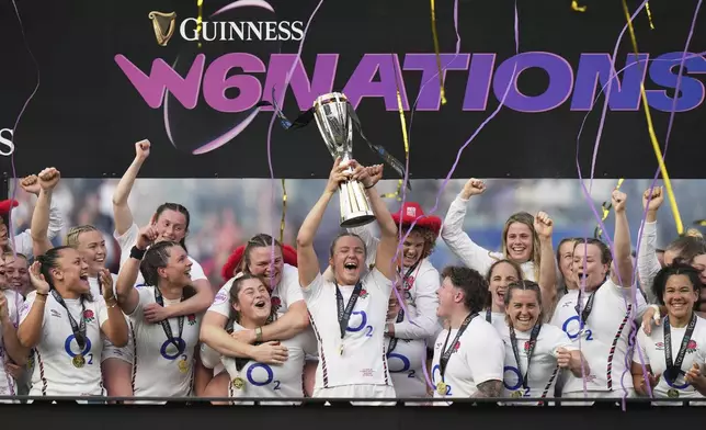 England's captain Zoe Aldcroft, centre, lifts the trophy at the presentation ceremony following the Women's Six Nations rugby union match at Twickenham stadium in London, Saturday, April 26, 2025. (AP Photo/Alastair Grant)