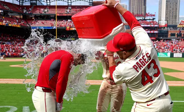 St. Louis Cardinals' Pedro Pagés (43) and Nolan Gorman dump a cooler of water on Nolan Arenado, left, in celebration of the Cardinals win against Milwaukee Brewers during a baseball game Saturday, April 26, 2025, in St. Louis. (AP Photo/Scott Kane)
