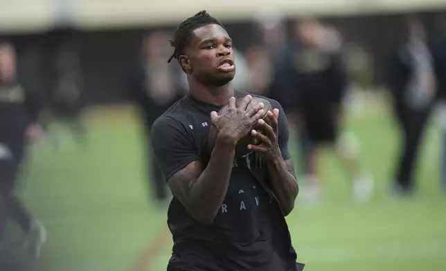 FILE - Colorado wide receiver Travis Hunter (12) takes part in passing drills during Colorado's NFL football pro day Friday, April 4, 2025, in Boulder, Colo. (AP Photo/David Zalubowsk,File)