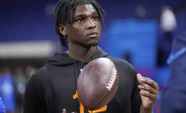 FILE - Miami quarterback Cam Ward watches a drill at the NFL football scouting combine in Indianapolis, Saturday, March 1, 2025. (AP Photo/George Walker IV,File)
