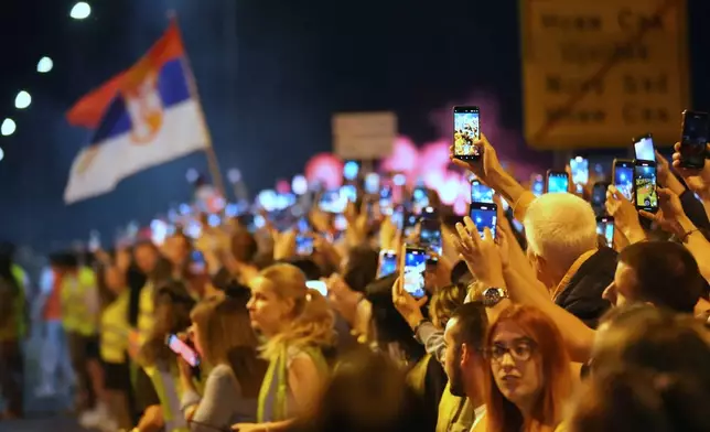 People welcome 80 Serbian university students who cycled more than 1,300 kilometers (780 miles) during last week, from Novi Sad to Strasbourg, France, to draw EU attention to their months-long protests against corruption, in Novi Sad, Serbia, Tuesday, April 22, 2025. (AP Photo/Darko Vojinovic)