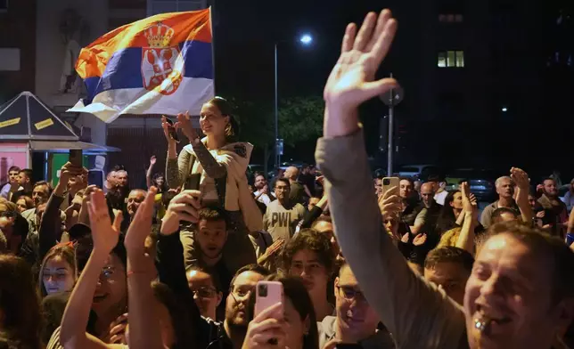 People welcome 80 Serbian university students who cycled more than 1,300 kilometers (780 miles) during last week, from Novi Sad to Strasbourg, France, to draw EU attention to their months-long protests against corruption, in Novi Sad, Serbia, Tuesday, April 22, 2025. (AP Photo/Darko Vojinovic)