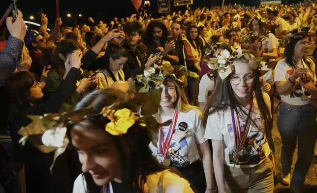 People welcome 80 Serbian university students who cycled more than 1,300 kilometers (780 miles) during last week, from Novi Sad to Strasbourg, France, to draw EU attention to their months-long protests against corruption, in Novi Sad, Serbia, Tuesday, April 22, 2025. (AP Photo/Darko Vojinovic)