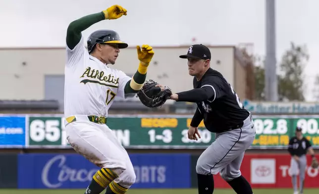 Chicago White Sox first baseman Andrew Vaughn (25) tags out Athletics' Luis Urías (17) during the fourth inning of a baseball game Sunday, April 27, 2025, in West Sacramento, Calif. (AP Photo/Sara Nevis)