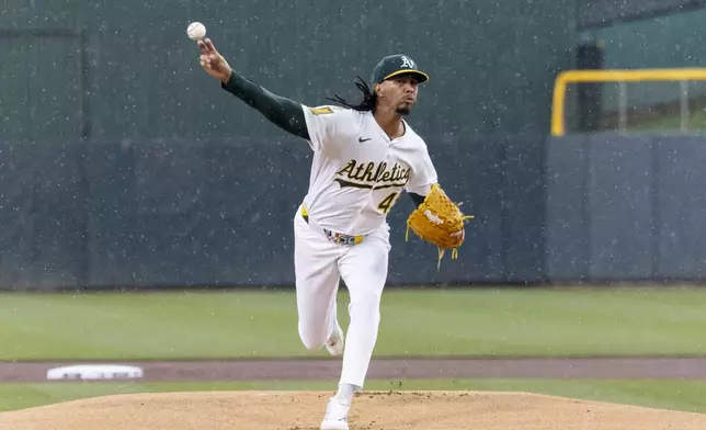 Athletics pitcher Osvaldo Bido throws in the rain to the Chicago White Sox during the first inning of a baseball game Sunday, April 27, 2025, in West Sacramento, Calif. (AP Photo/Sara Nevis)