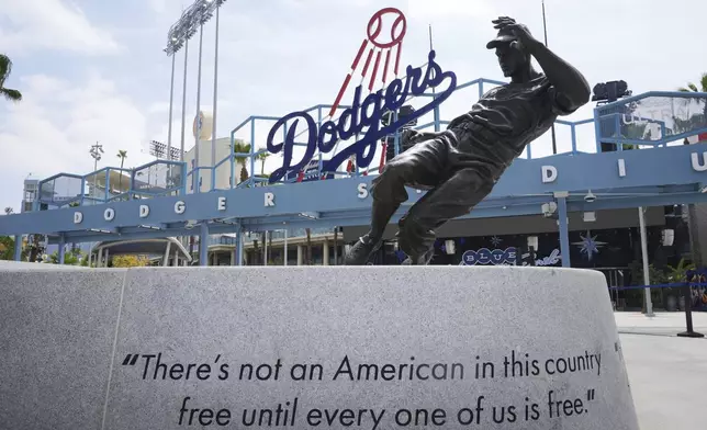 A statue of Jackie Robinson is seen at Dodger Stadium on Jackie Robinson Day before a baseball game between the Los Angeles Dodgers and Colorado Rockies Tuesday, April 15, 2025, in Los Angeles. (AP Photo/Damian Dovarganes)
