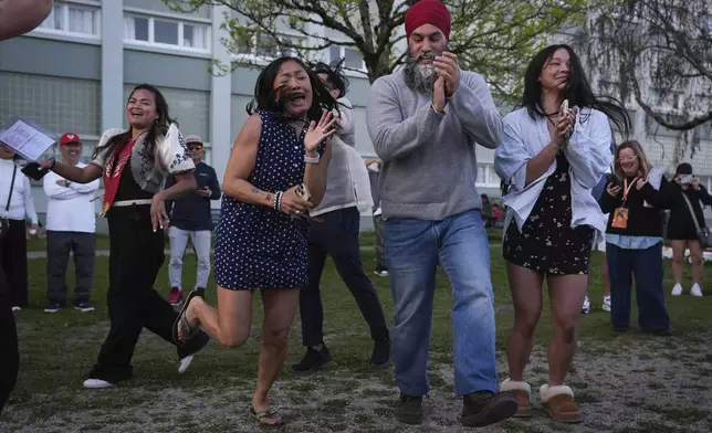 NDP Leader Jagmeet Singh, center right, dances with attendees during a campaign stop at a Lapu Lapu Day block party, in Vancouver, British Columbia, Saturday, April 26, 2025. (Darryl Dyck/The Canadian Press via AP)