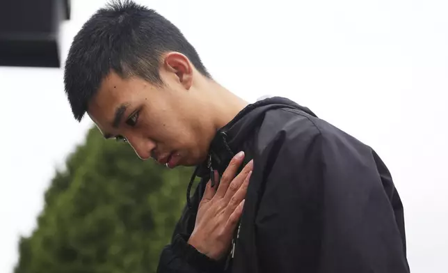 A person pays their respects at a growing memorial the day after a driver killed multiple people during a Filipino community festival Sunday, April 27, 2025, in Vancouver, British Columbia. (AP Photo/Lindsey Wasson)