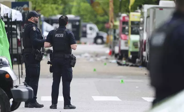Vancouver Police survey the scene after a driver killed multiple people Saturday during a Filipino community festival Sunday, April 27, 2025, in Vancouver, British Columbia. (AP Photo/Lindsey Wasson)