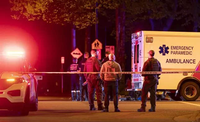 Vancouver police secure the scene after a car drove into a crowd at the Lapu Lapu Festival in Vancouver, British Columbia, Saturday April 26, 2025. (Rich Lam/The Canadian Press via AP)
