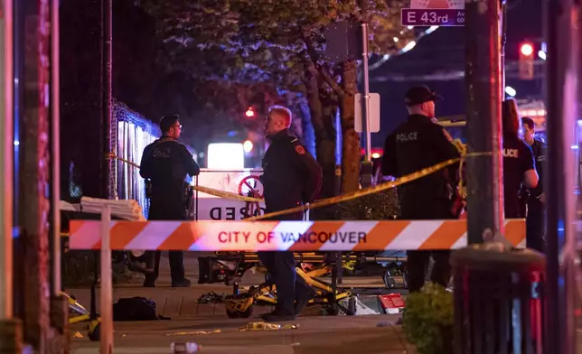 Vancouver police secure the scene after a car drove into a crowd at the Lapu Lapu Festival in Vancouver, British Columbia, Saturday April 26, 2025. (Rich Lam/The Canadian Press via AP)
