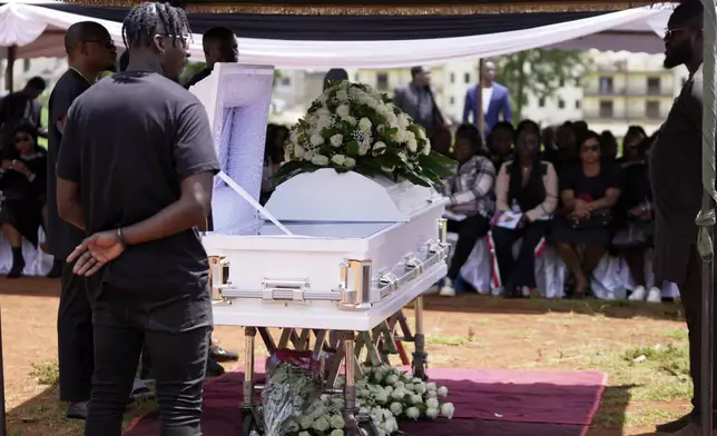 Mourners listen during the funeral service for Nigerian Ladi Anzaki Olubunmi, a TikTok content moderator employed by subcontractor Teleperformance, at the Langata cemetery in Nairobi, Kenya Thursday, April. 17, 2025. (AP Photo/Brian Inganga)