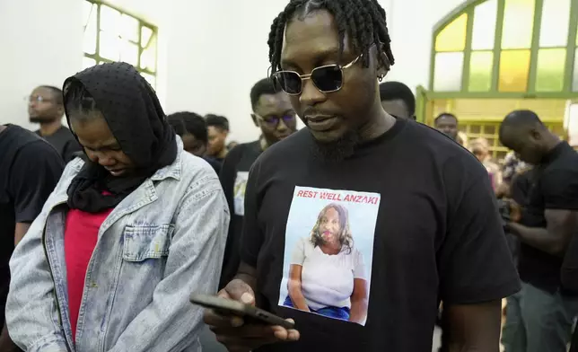 Mourners sing during the funeral service of Nigerian Ladi Anzaki Olubunmi, a TikTok content moderator employed by subcontractor Teleperformance, at Chiromo Funeral Parlour in Nairobi, Kenya Thursday, April. 17, 2025. (AP Photo/Brian Inganga)