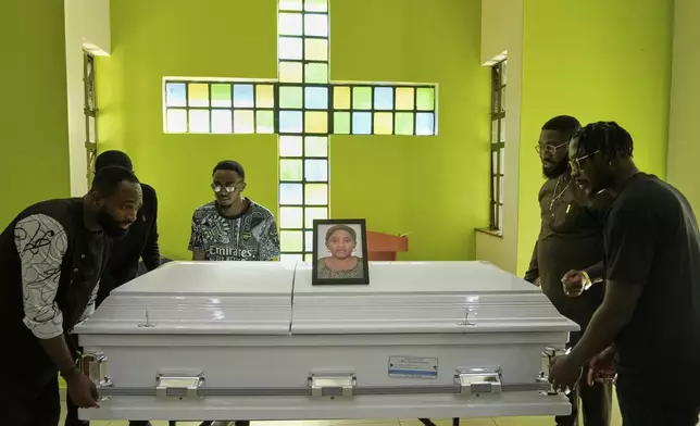 Mourners carry the casket of Nigerian Ladi Anzaki Olubunmi, a TikTok content moderator employed by subcontractor Teleperformance, at Chiromo Funeral Parlour in Nairobi, Kenya Thursday, April. 17, 2025. (AP Photo/Brian Inganga)