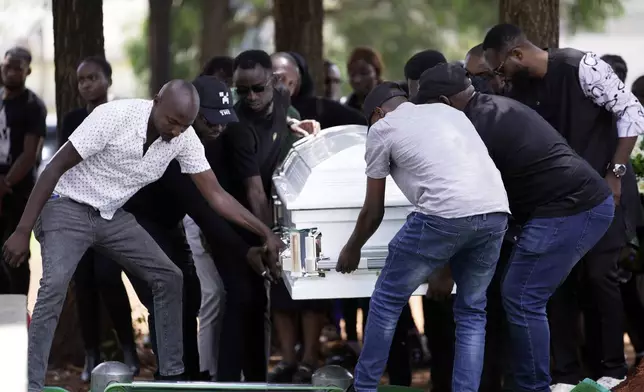 Mourners bury the body of Nigerian Ladi Anzaki Olubunmi, a TikTok content moderator employed by subcontractor Teleperformance, at the Langata cemetery in Nairobi, Kenya Thursday, April. 17, 2025. (AP Photo/Brian Inganga)