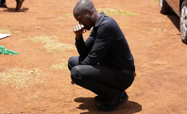 Tauheed Tayo Yakubu, mourns during a funeral ceremony for Nigerian Ladi Anzaki Olubunmi, a TikTok content moderator employed by subcontractor Teleperformance, at the Langata cemetery in Nairobi, Kenya Thursday, April. 17, 2025. (AP Photo/Brian Inganga)