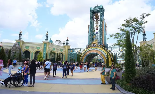 Guests arrive at the main entrance to Epic Universe Theme Park at Universal Resort Orlando Thursday, April 10, 2025, in Orlando, Fla. (AP Photo/John Raoux)