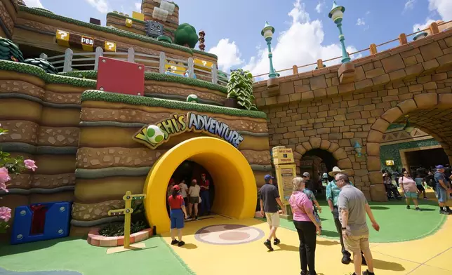 Guests stroll around the various parts of Super Nintendo World at Epic Universe at Universal Resort Orlando Thursday, April 10, 2025, in Orlando, Fla. (AP Photo/John Raoux)