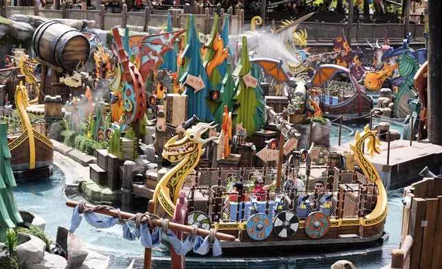 Park guests ride the Fyre Drill boat ride at How to Train Your Dragon – Isle of Berk at Epic Universe Theme Park at Universal Resort Orlando Thursday, April 10, 2025, in Orlando, Fla. (AP Photo/John Raoux)