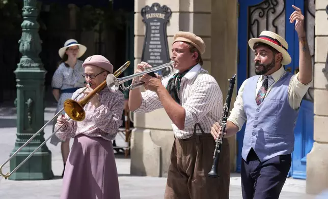 Street musicians perform for guests at The Wizarding World of Harry Potter, Ministry of Magic at Epic Universe at Universal Resort Orlando Thursday, April 10, 2025, in Orlando, Fla. (AP Photo/John Raoux)