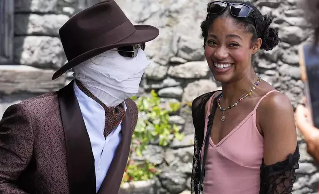 The invisible man interacts with a guest in Dark Universe at Epic Universe Theme Park at Universal Resort Orlando Thursday, April 10, 2025, in Orlando, Fla. (AP Photo/John Raoux)