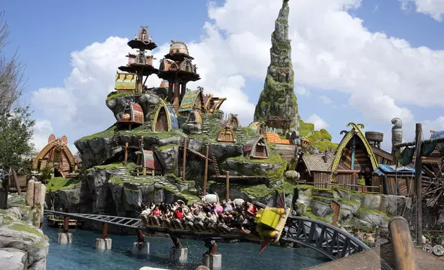 Guest ride a roller coaster in the How To Train Your Dragon – Isle Of Berk at Epic Universe theme park at Universal Resort Orlando Thursday, April 10, 2025, in Orlando, Fla. (AP Photo/John Raoux)