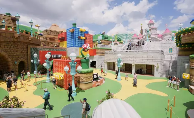 Guests stroll around the various parts of Super Nintendo World at Epic Universe at Universal Resort Orlando Thursday, April 10, 2025, in Orlando, Fla. (AP Photo/John Raoux)