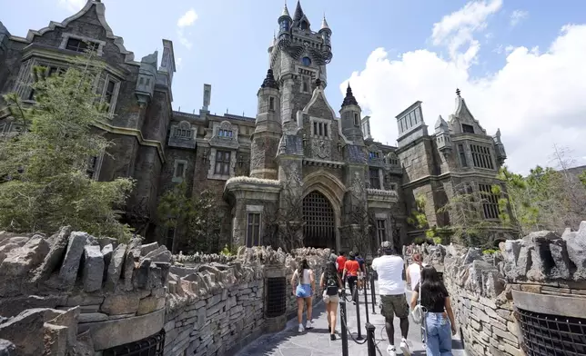 Guests enter the The Frankenstein Castle in Dark Universe at Epic Universe Theme Park at Universal Resort Orlando Thursday, April 10, 2025, in Orlando, Fla. (AP Photo/John Raoux)