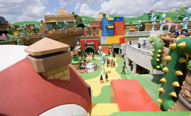 Guests stroll around the various parts of Super Nintendo World at Epic Universe at Universal Resort Orlando Thursday, April 10, 2025, in Orlando, Fla. (AP Photo/John Raoux)