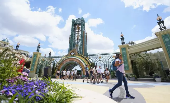 Guests arrive at the main entrance to Epic Universe Theme Park at Universal Resort Orlando Thursday, April 10, 2025, in Orlando, Fla. (AP Photo/John Raoux)