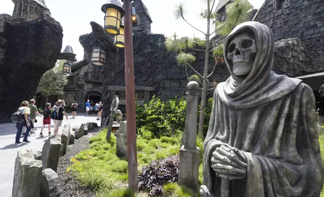 Guests tour the Dark Universe at Epic Universe Theme Park at Universal Resort Orlando Thursday, April 10, 2025, in Orlando, Fla. (AP Photo/John Raoux)