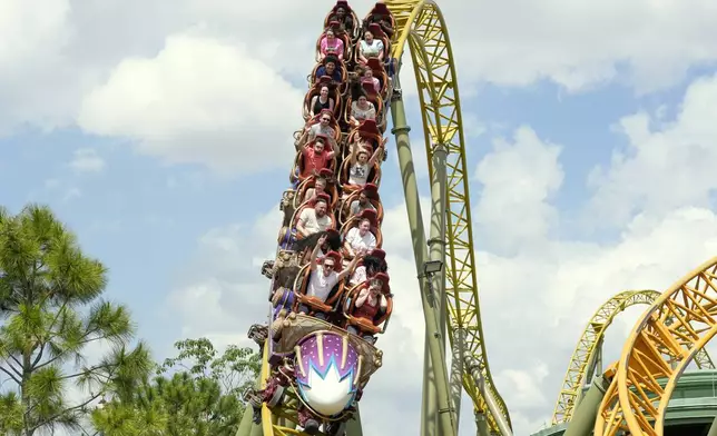 Guests ride on the Stardust Racers roller coaster at Epic Universe Theme Park at Universal Resort Orlando Thursday, April 10, 2025, in Orlando, Fla. (AP Photo/John Raoux)