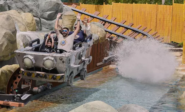 Guests ride the Mine-Cart Madness coaster in Super Nintendo World at Epic Universe at Universal Resort Orlando Thursday, April 10, 2025, in Orlando, Fla. (AP Photo/John Raoux)