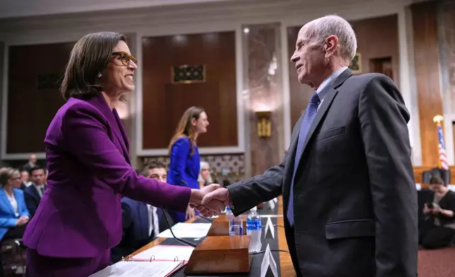 Former Justice Department attorney Liz Oyer, left, is welcomed by Sen. Peter Welch, D-Vt., to testify to House and Senate Judiciary Committee members at a hearing about the Justice Department, on Capitol Hill in Washington, Monday, April 7, 2025. (AP Photo/J. Scott Applewhite)
