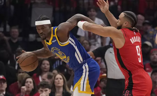 Houston Rockets forward Dillon Brooks (9) defends against Golden State Warriors forward Jimmy Butler III (10) during the first half of Game 2 of an NBA basketball first-round playoff series against the Houston Rockets in Houston, Wednesday, April 23, 2025. (AP Photo/Karen Warren)