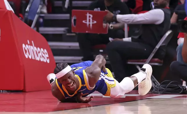 Golden State Warriors' Jimmy Butler III writhes in pain after injuring himself in 1st quarter against Houston Rockets in Game 2 of First Round of NBA Playoffs at Toyota Center in Houston, Texas on Wednesday, April 23, 2025. (Scott Strazzante/San Francisco Chronicle via AP)