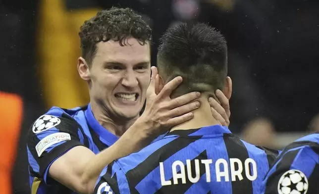 Inter Milan's Benjamin Pavard, left, celebrates with his teammate Lautaro Martinez after scoring his side's second goal during the Champions League quarterfinal second leg soccer match between Inter Milan and Bayern Munich at the San Siro stadium in Milan, Italy, Wednesday, April 16, 2025. (AP Photo/Luca Bruno)