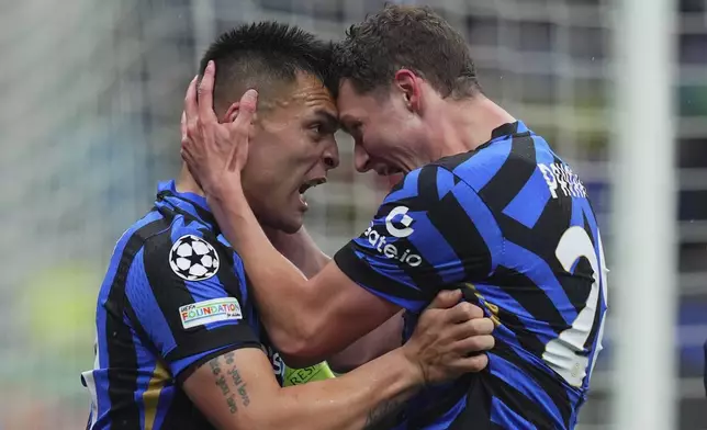 Inter Milan's Lautaro Martinez celebrates after scoring with teammate Benjamin Pavard, right, during the Champions League quarter final soccer match between Inter Milan and Bayern Munich at San Siro Stadium in Milan, North Italy, Wednesday April 16, 2025. (Spada/LaPresse via AP)