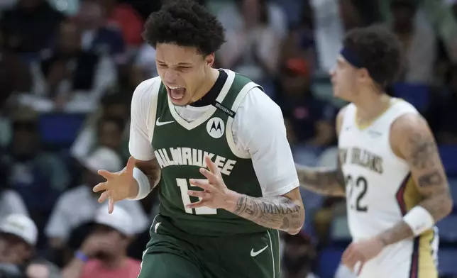 Milwaukee Bucks guard Ryan Rollins (13) reacts after making a 3-point basket against the New Orleans Pelicans during the first half of an NBA basketball game in New Orleans, Sunday, April 6, 2025. (AP Photo/Matthew Hinton)