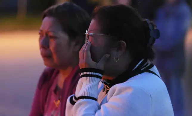 Liza Ahyeng wipes away tears at a memorial for victims after a vehicle drove into a crowd during a Filipino heritage festival in Vancouver, British Columbia, Sunday, April 27, 2025. (AP Photo/Lindsey Wasson)