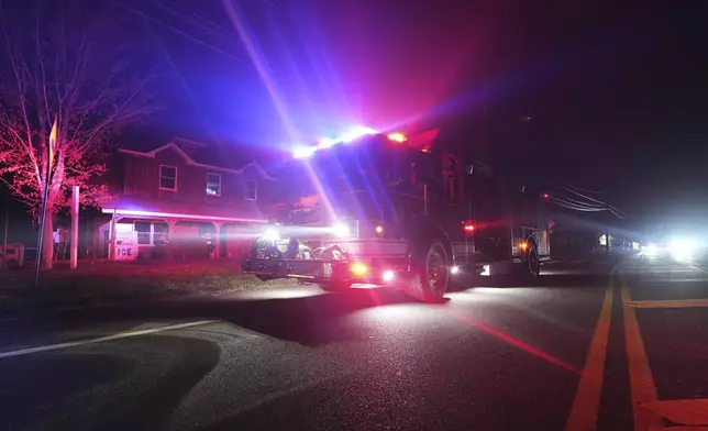 Firefighters respond to a wildfire on Tuesday, April 22, 2025, in Waretown, N.J. (AP Photo/Chris Szagola)